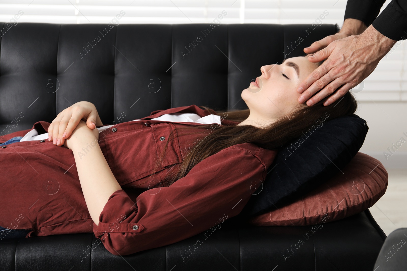 Photo of Psychologist working with patient during hypnosis session indoors, closeup