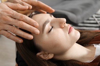 Photo of Psychologist working with patient during hypnosis session indoors, closeup