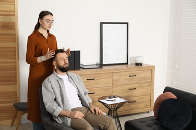 Psychologist working with patient during hypnosis session indoors