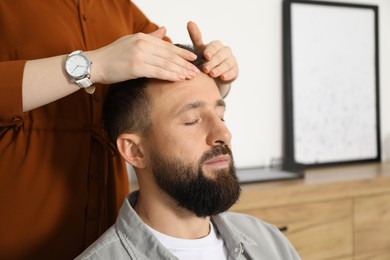 Photo of Psychologist working with patient during hypnosis session indoors, closeup. Space for text