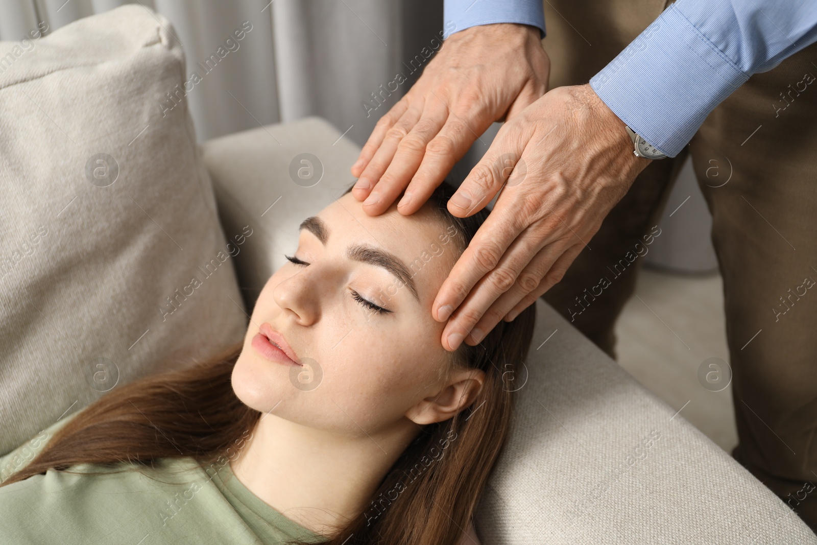 Photo of Psychologist working with patient during hypnosis session indoors, closeup