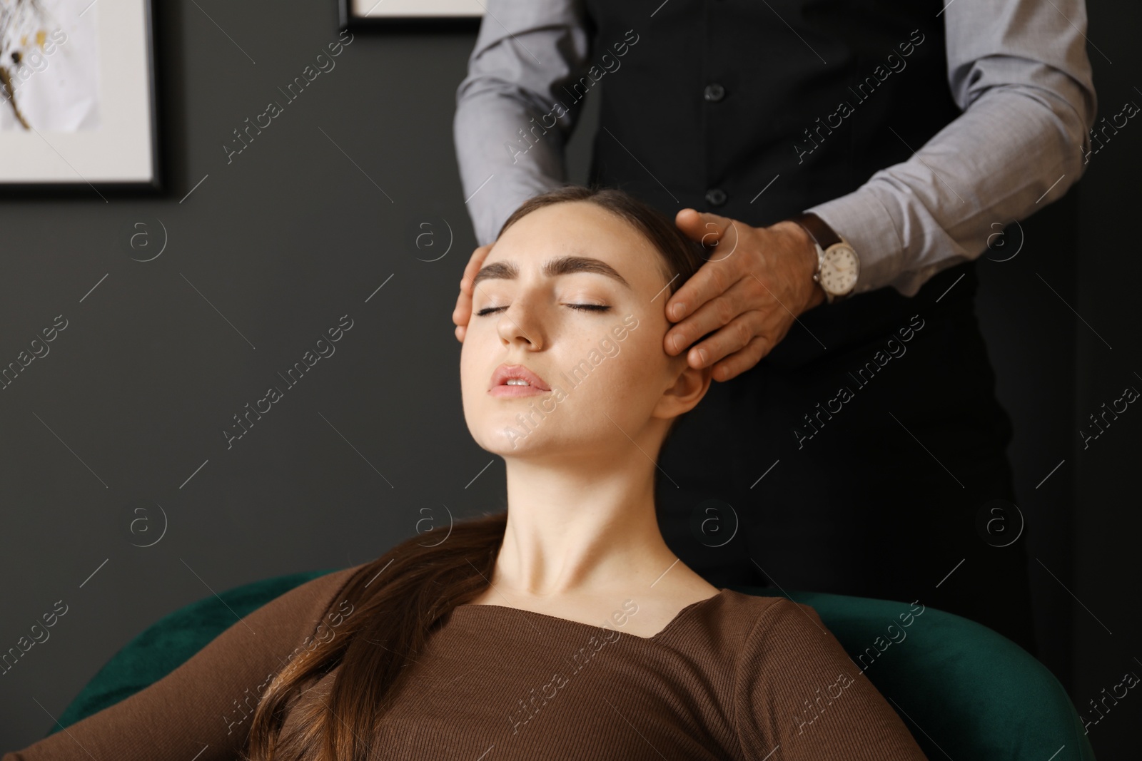 Photo of Psychologist working with patient during hypnosis session indoors, closeup