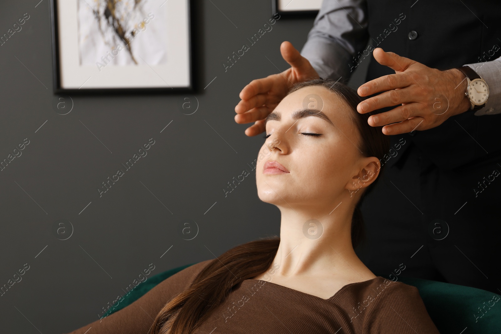 Photo of Psychologist working with patient during hypnosis session indoors, closeup. Space for text