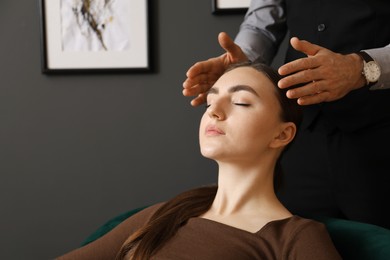 Photo of Psychologist working with patient during hypnosis session indoors, closeup. Space for text