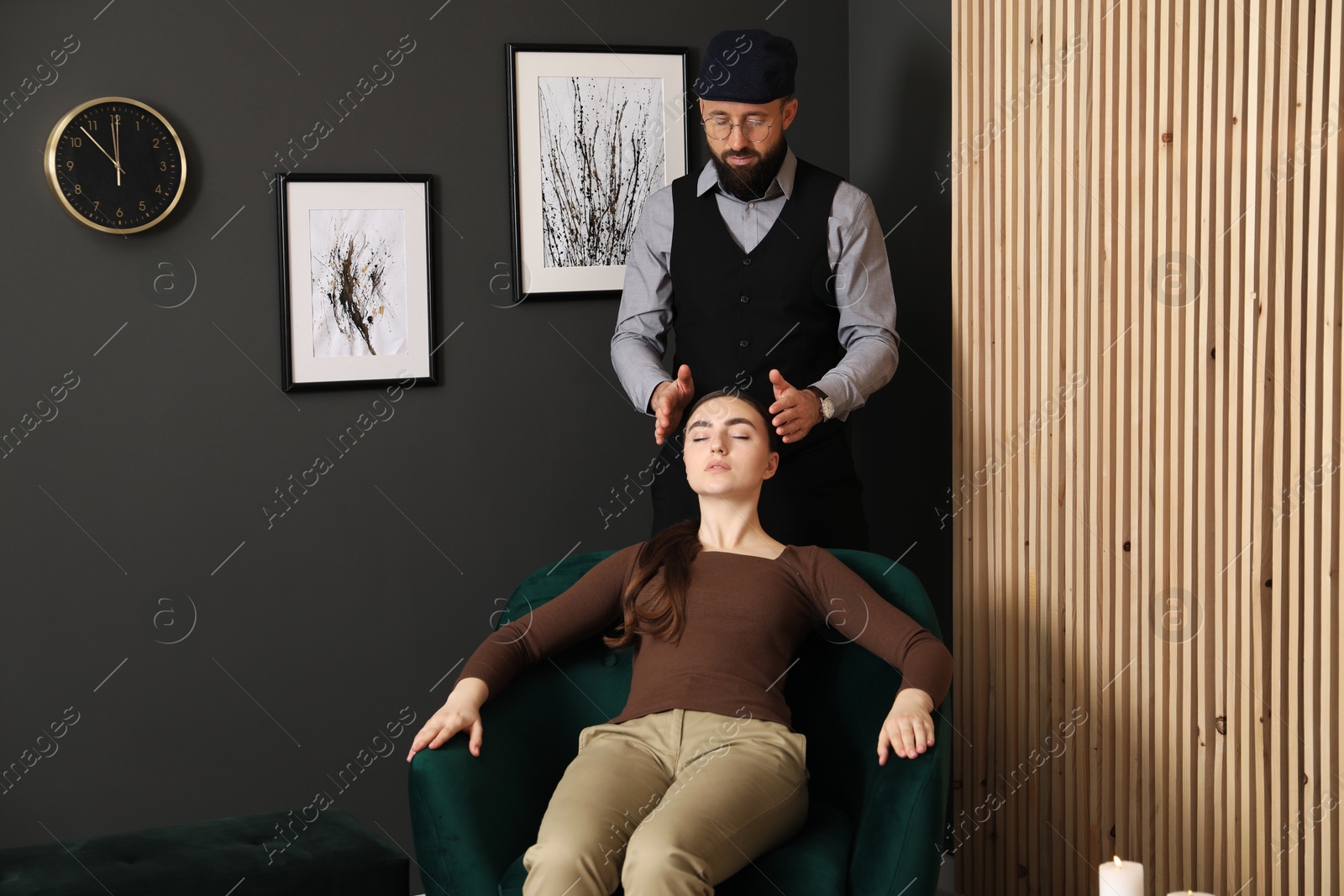 Photo of Psychologist working with patient during hypnosis session indoors