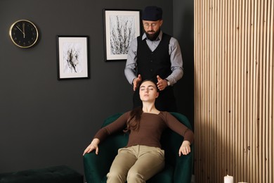 Photo of Psychologist working with patient during hypnosis session indoors