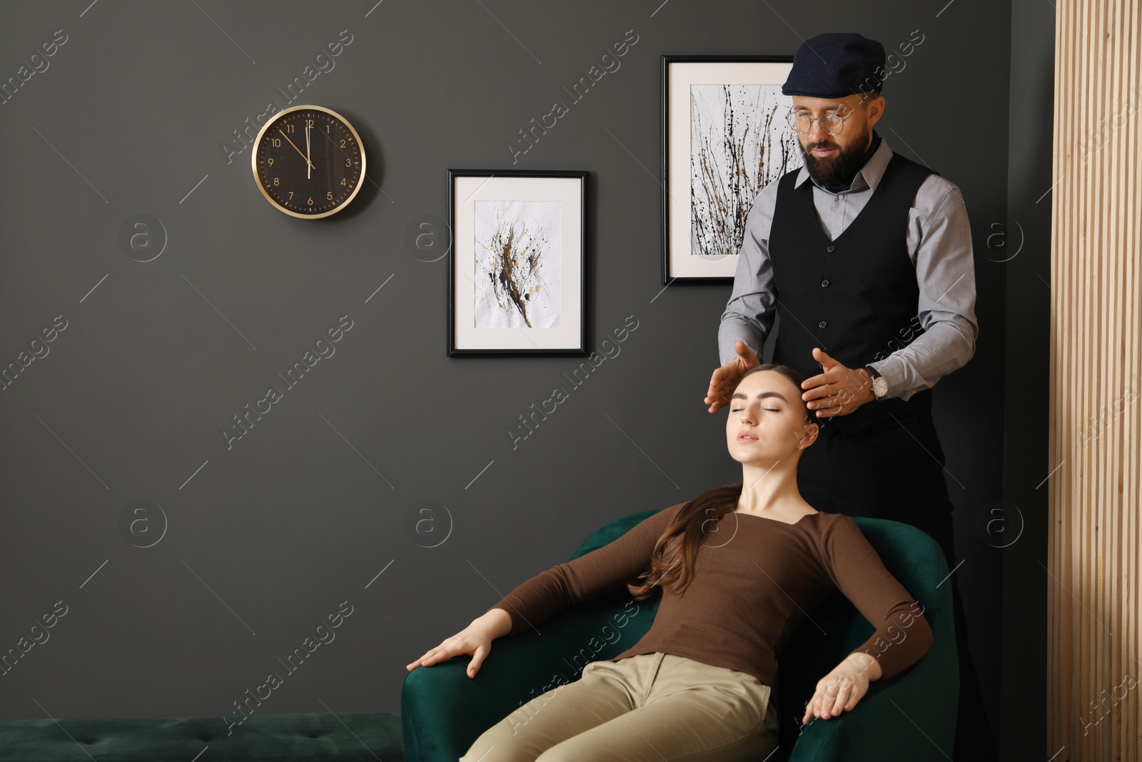 Photo of Psychologist working with patient during hypnosis session indoors