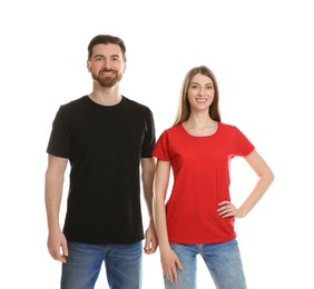 Photo of Woman and man wearing blank t-shirts on white background. Mockup for design