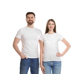 Photo of Woman and man wearing blank t-shirts on white background. Mockup for design