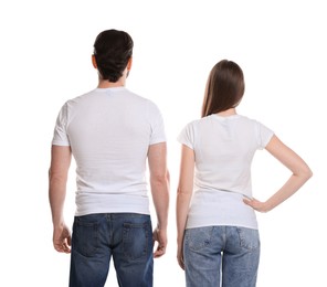 Photo of Woman and man wearing blank t-shirts on white background, back view. Mockup for design