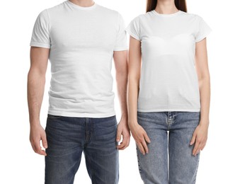 Photo of Woman and man wearing blank t-shirts on white background, closeup. Mockup for design