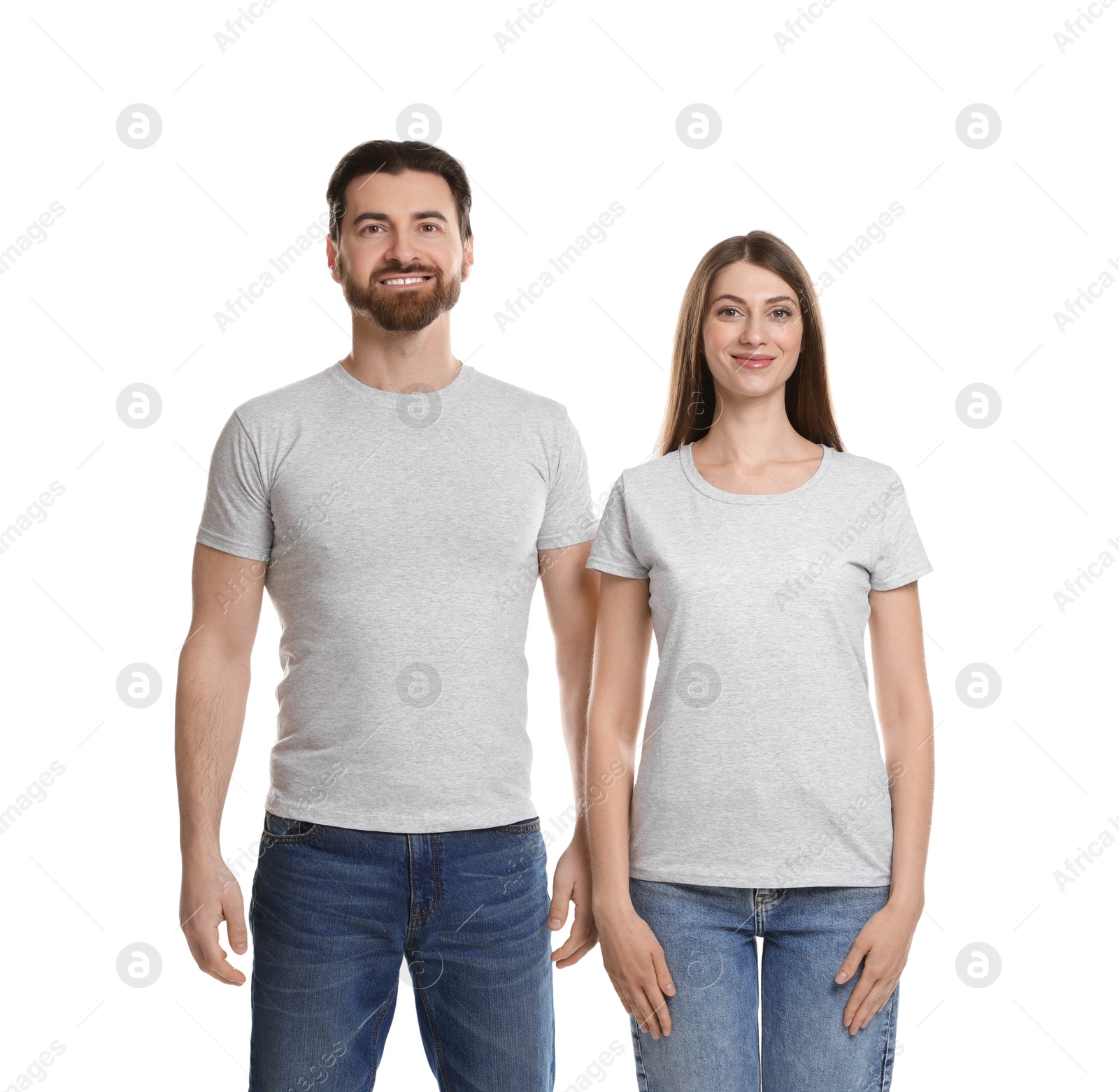 Photo of Woman and man wearing blank t-shirts on white background. Mockup for design