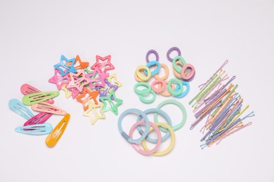 Photo of Different hair accessories on light background, flat lay