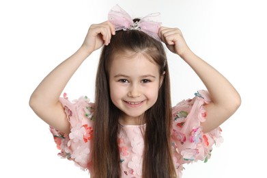 Photo of Happy little girl wearing beautiful hair accessory on white background