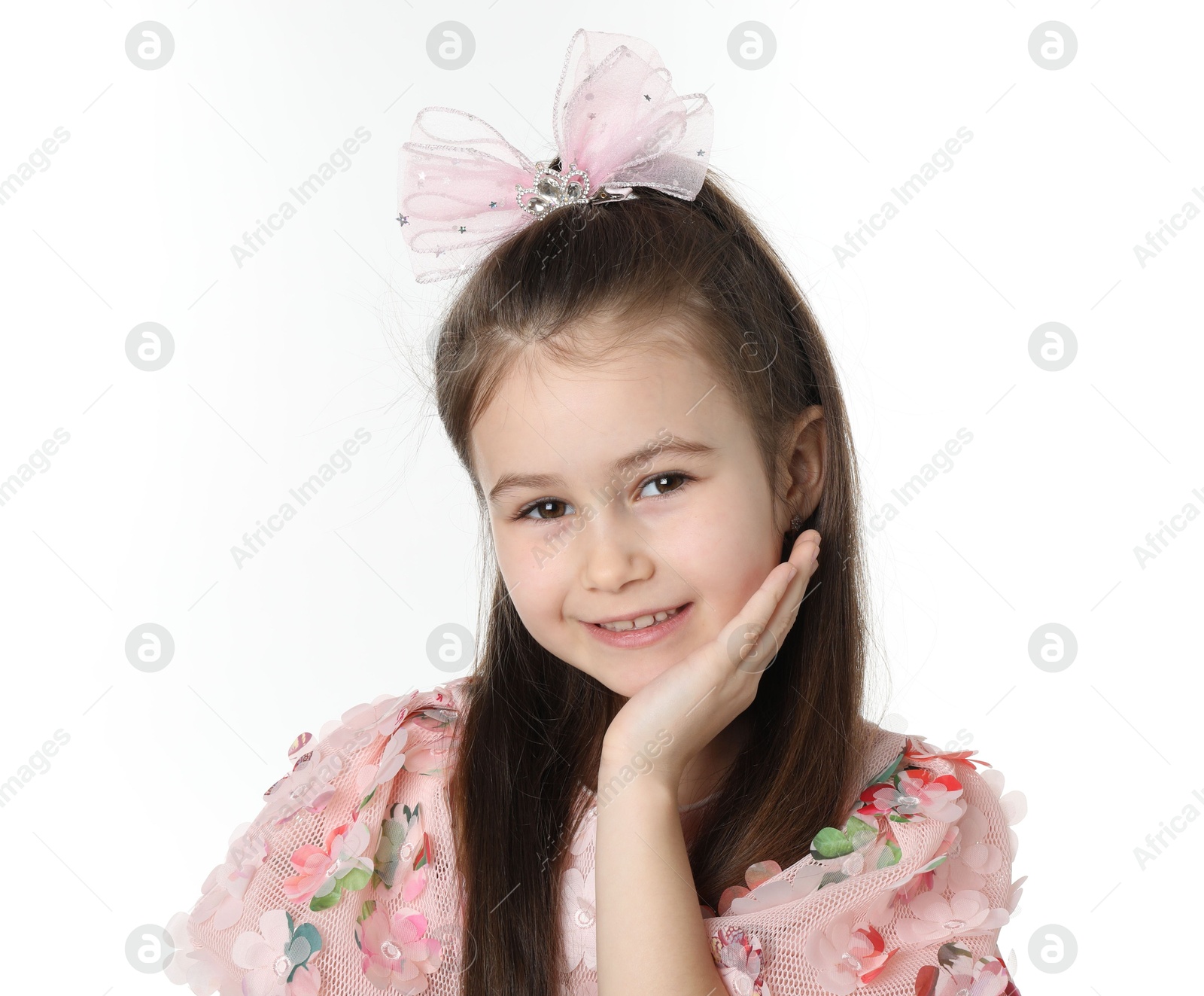 Photo of Happy little girl wearing beautiful hair accessory on white background