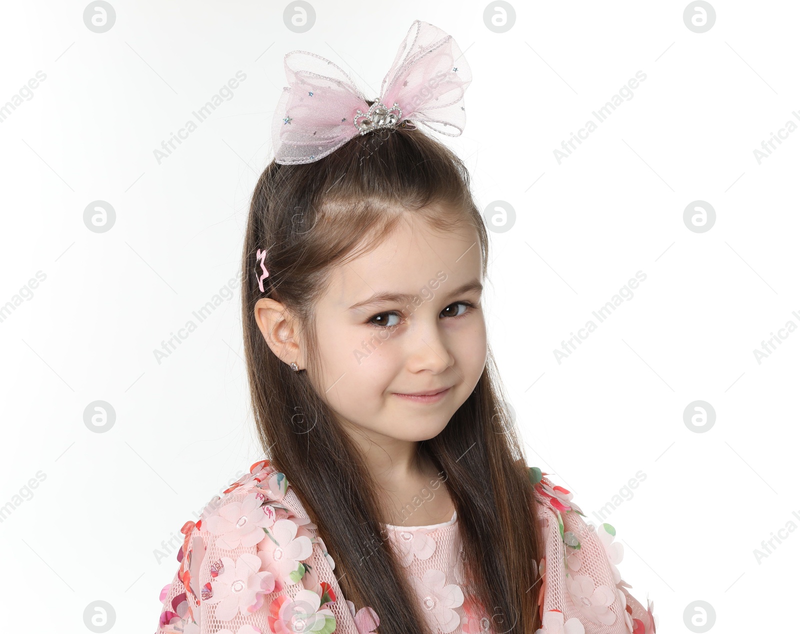 Photo of Smiling little girl wearing beautiful hair accessories on white background