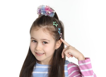 Photo of Happy little girl wearing beautiful hair accessories on white background