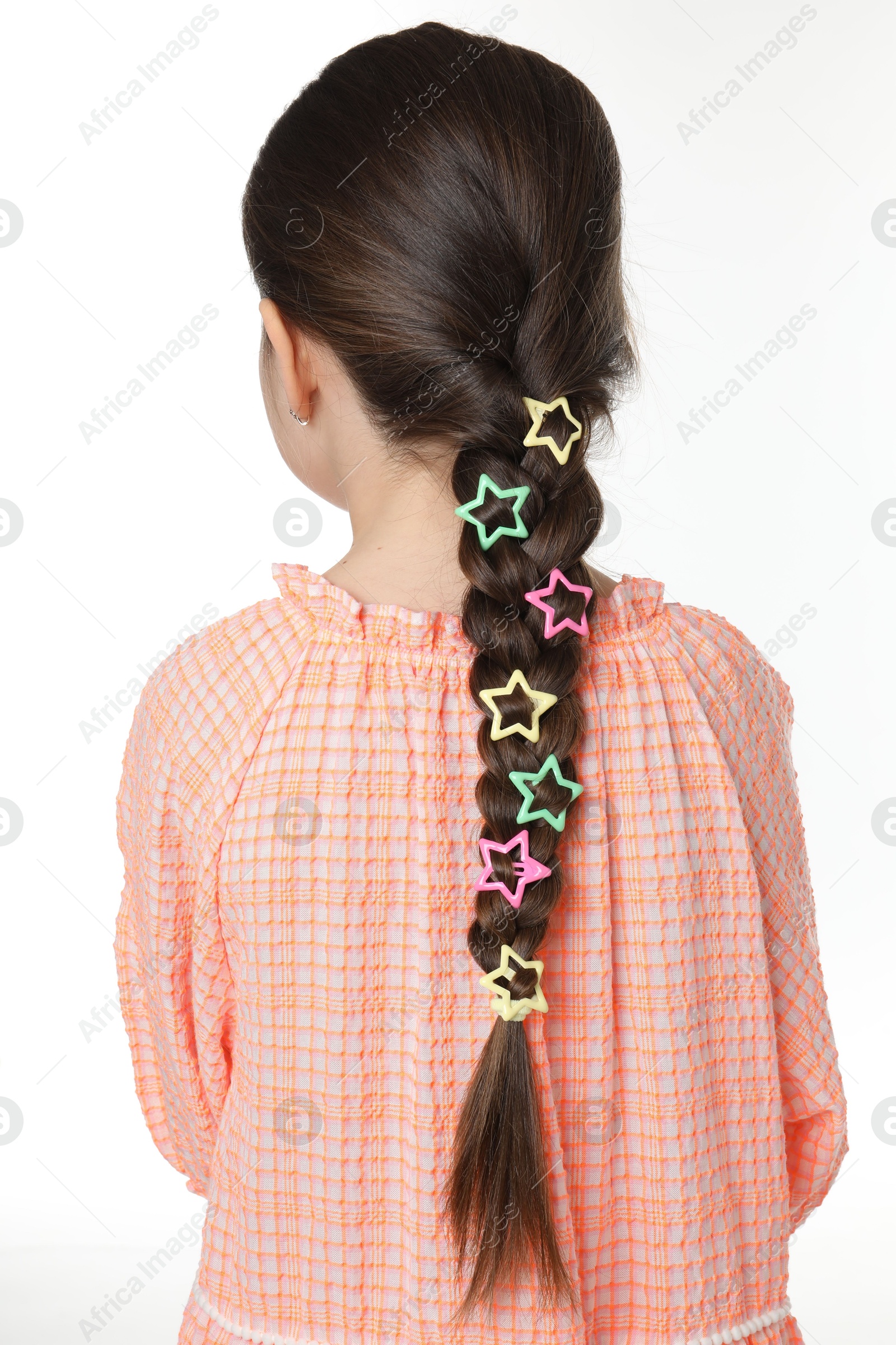 Photo of Little girl wearing beautiful hair accessories on white background, back view