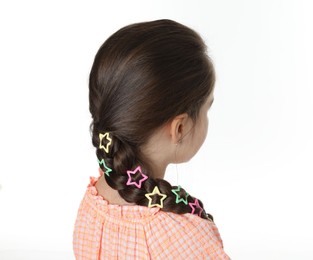 Photo of Little girl wearing beautiful hair accessories on white background