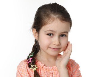 Photo of Little girl wearing beautiful hair accessories on white background