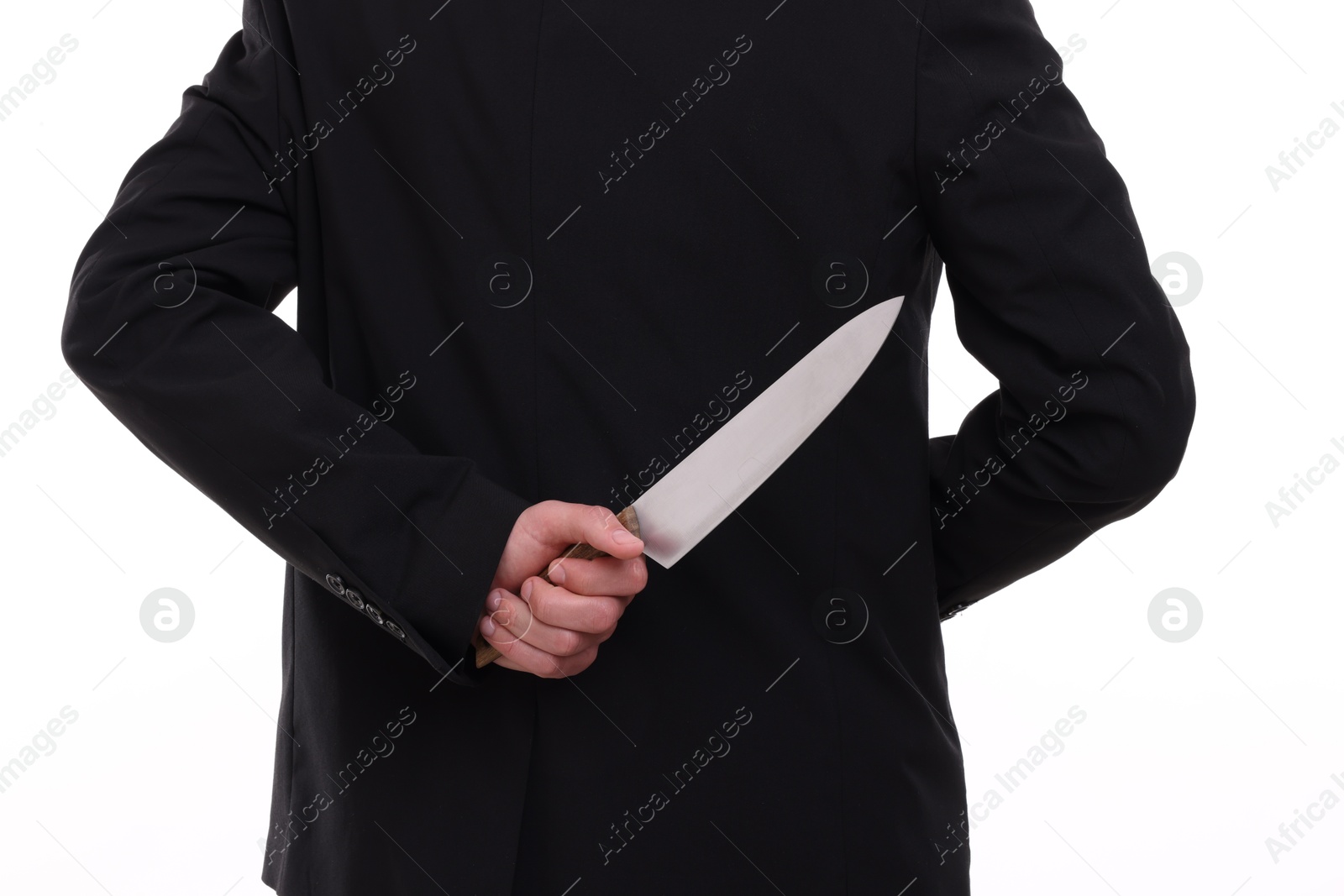 Photo of Businessman holding knife behind his back on white background, closeup