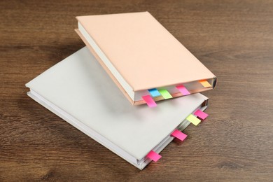 Photo of Books with colorful tabs on wooden table