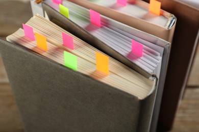 Photo of Books with colorful tabs on table, closeup