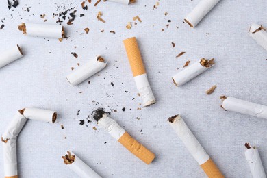 Photo of Many cigarette butts on light gray background, flat lay