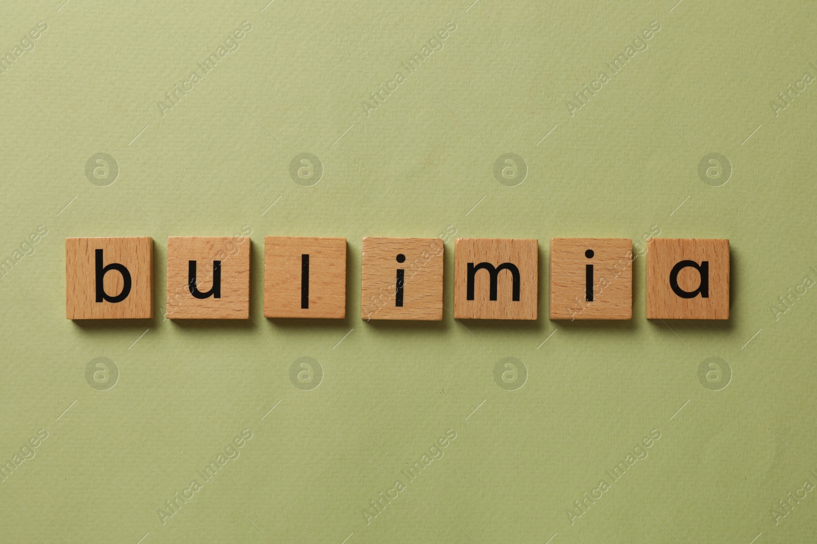 Photo of Word Bulimia on olive background, top view