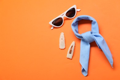 Photo of Stylish accessories on orange background, flat lay. Space for text