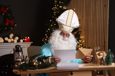 Photo of Saint Nicholas with letters in room decorated for Christmas