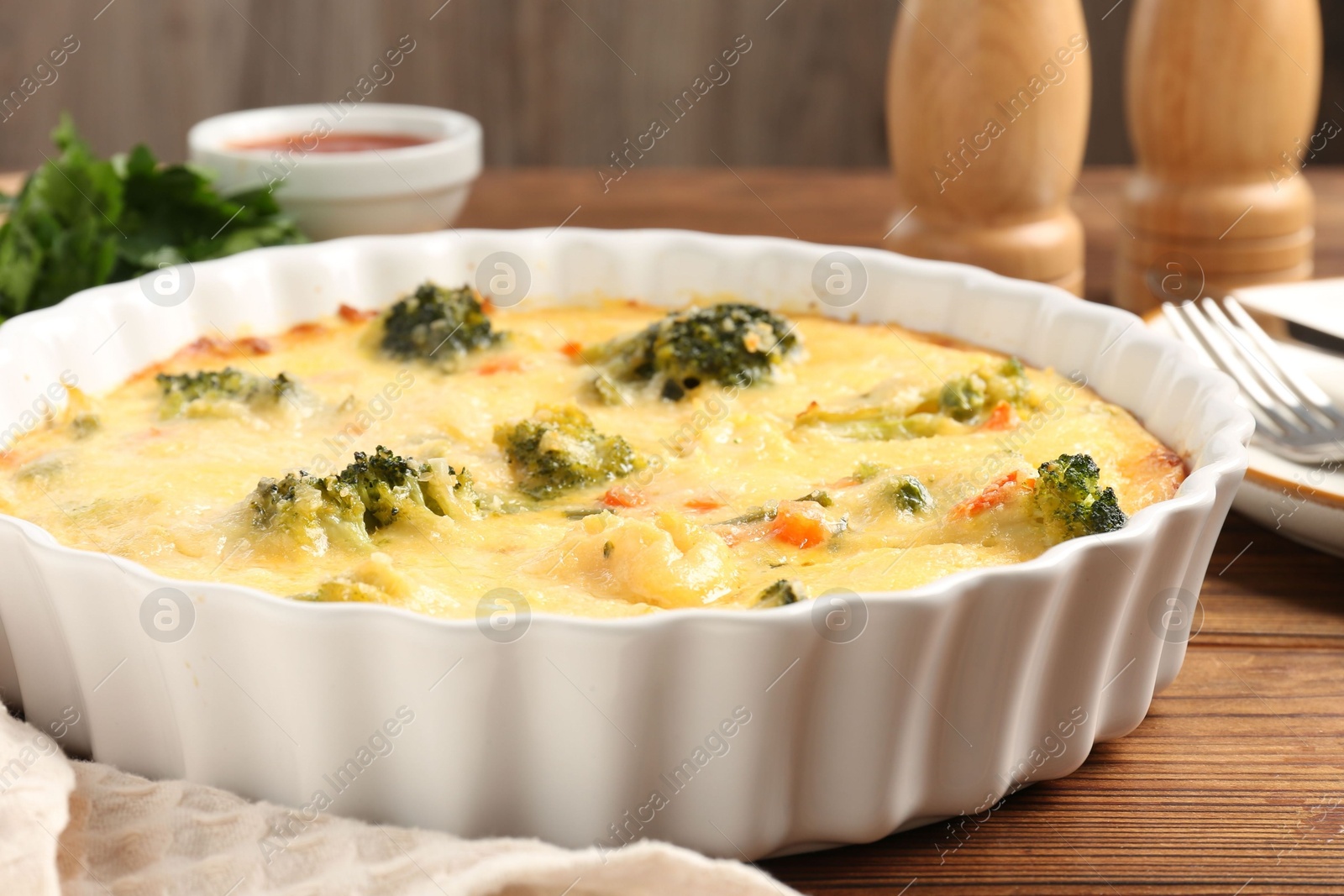 Photo of Delicious vegetable casserole served on wooden table, closeup