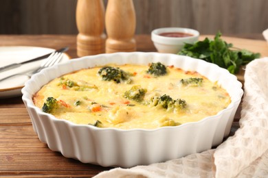 Photo of Delicious vegetable casserole served on wooden table, closeup