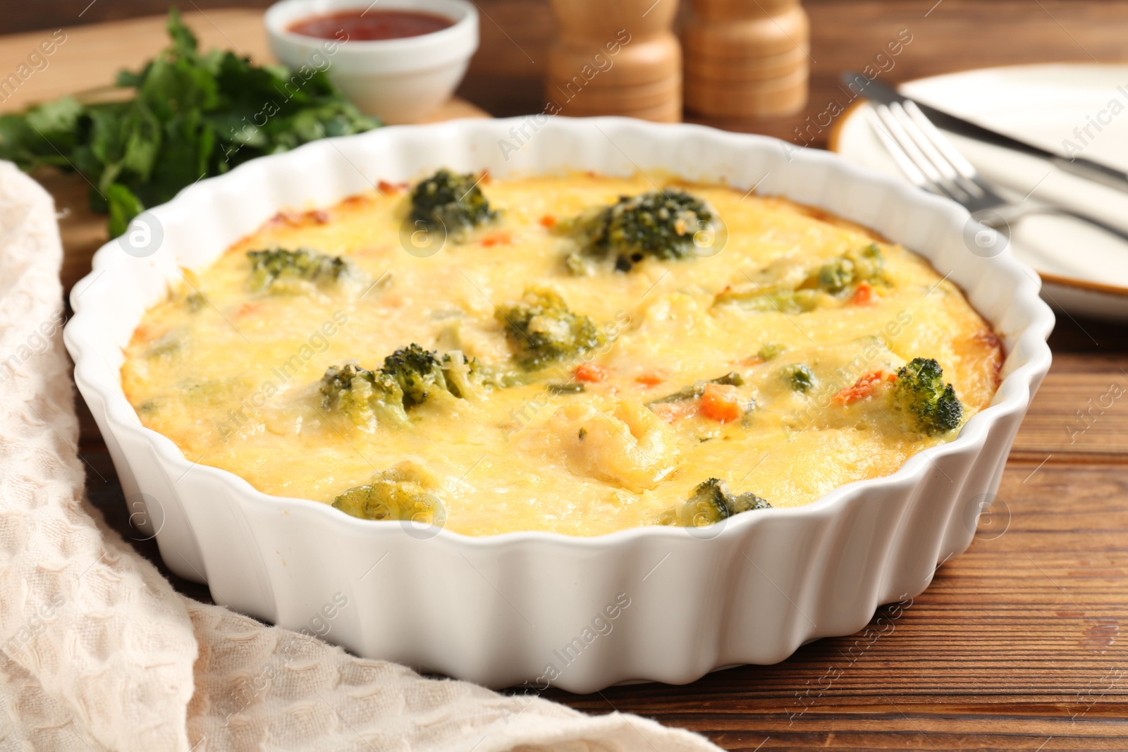 Photo of Delicious vegetable casserole served on wooden table, closeup