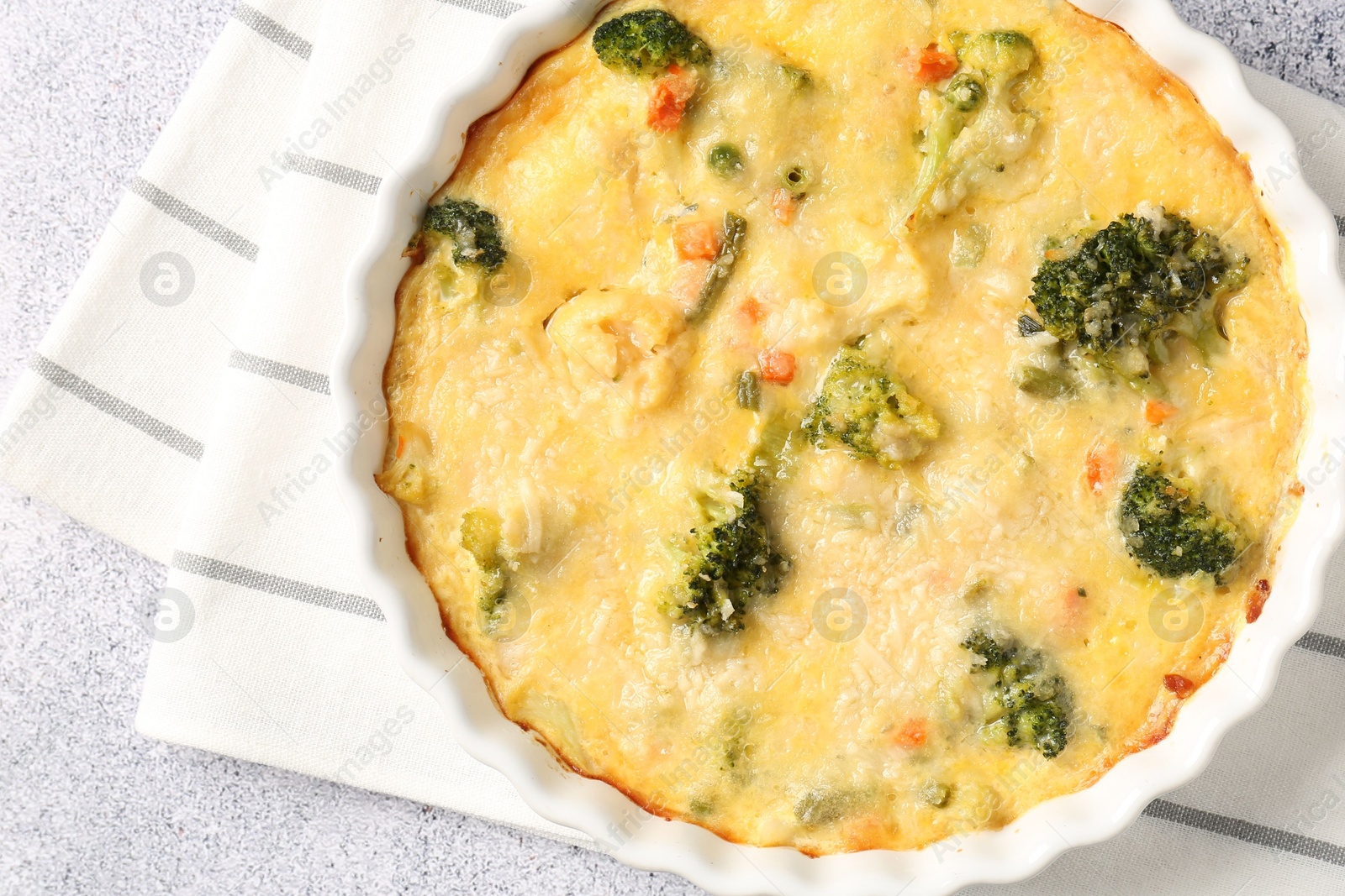 Photo of Delicious vegetable casserole on light table, top view