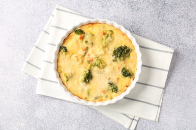 Photo of Delicious vegetable casserole on light table, top view