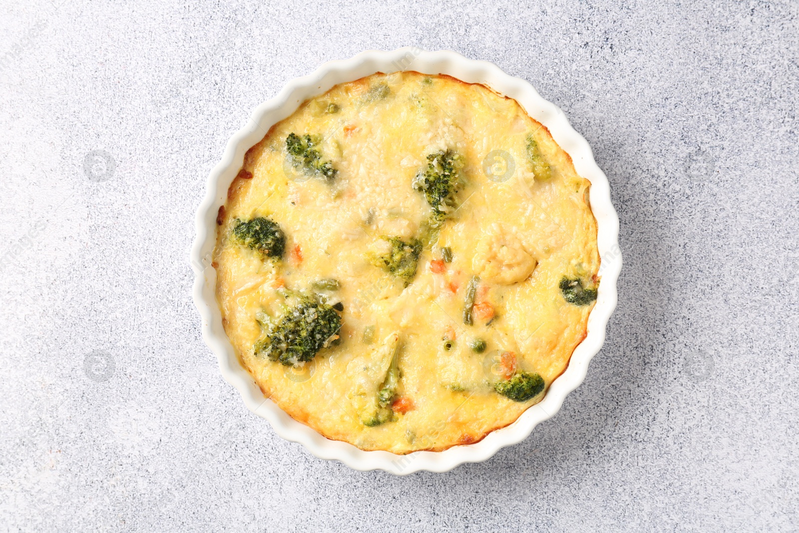 Photo of Delicious vegetable casserole on light table, top view