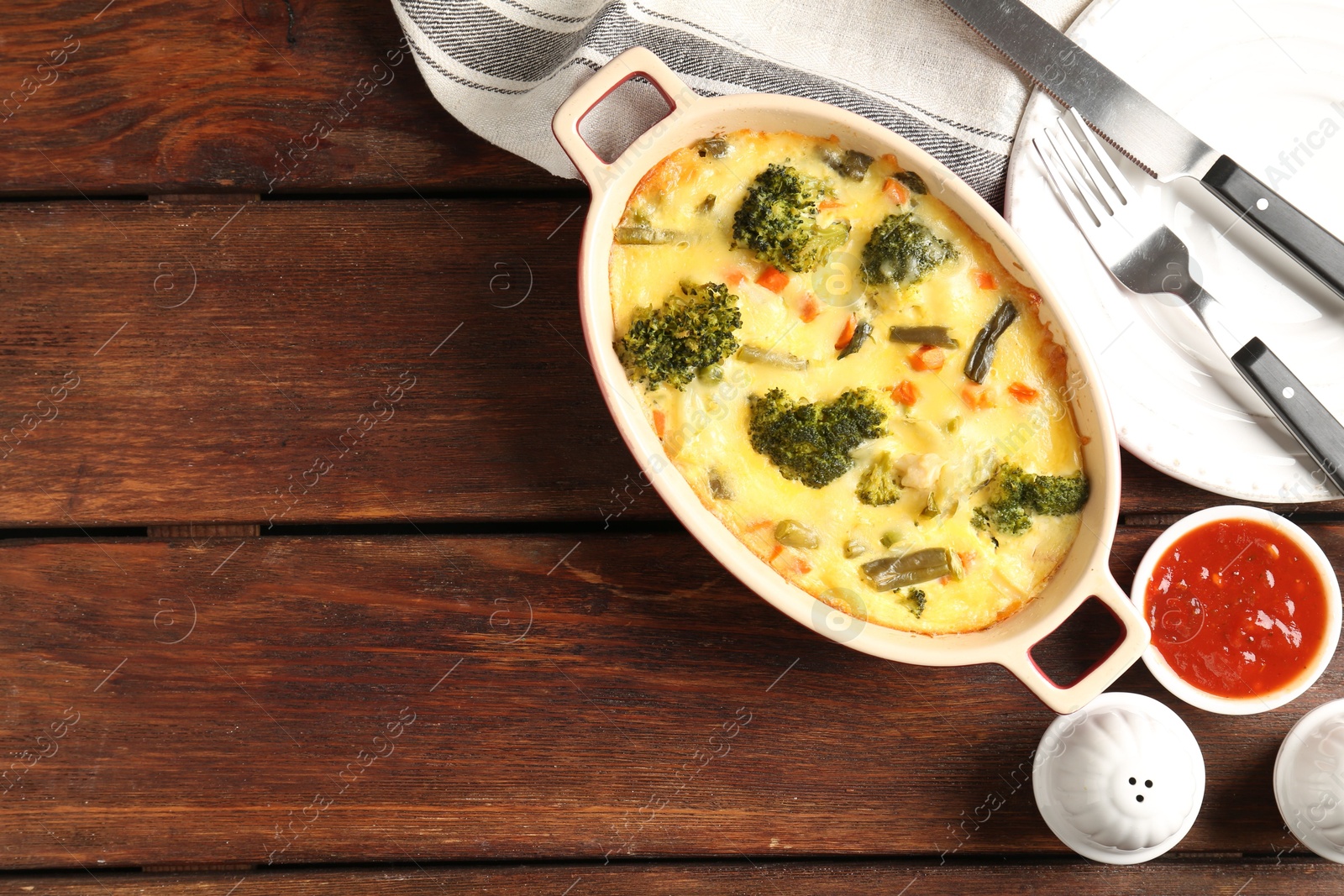 Photo of Delicious vegetable casserole served on wooden table, flat lay. Space for text