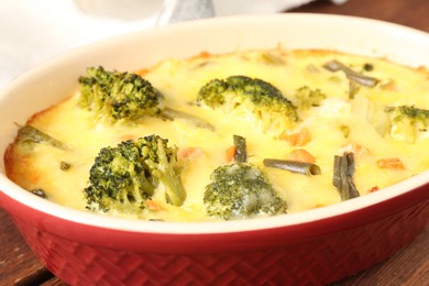 Photo of Delicious vegetable casserole on wooden table, closeup