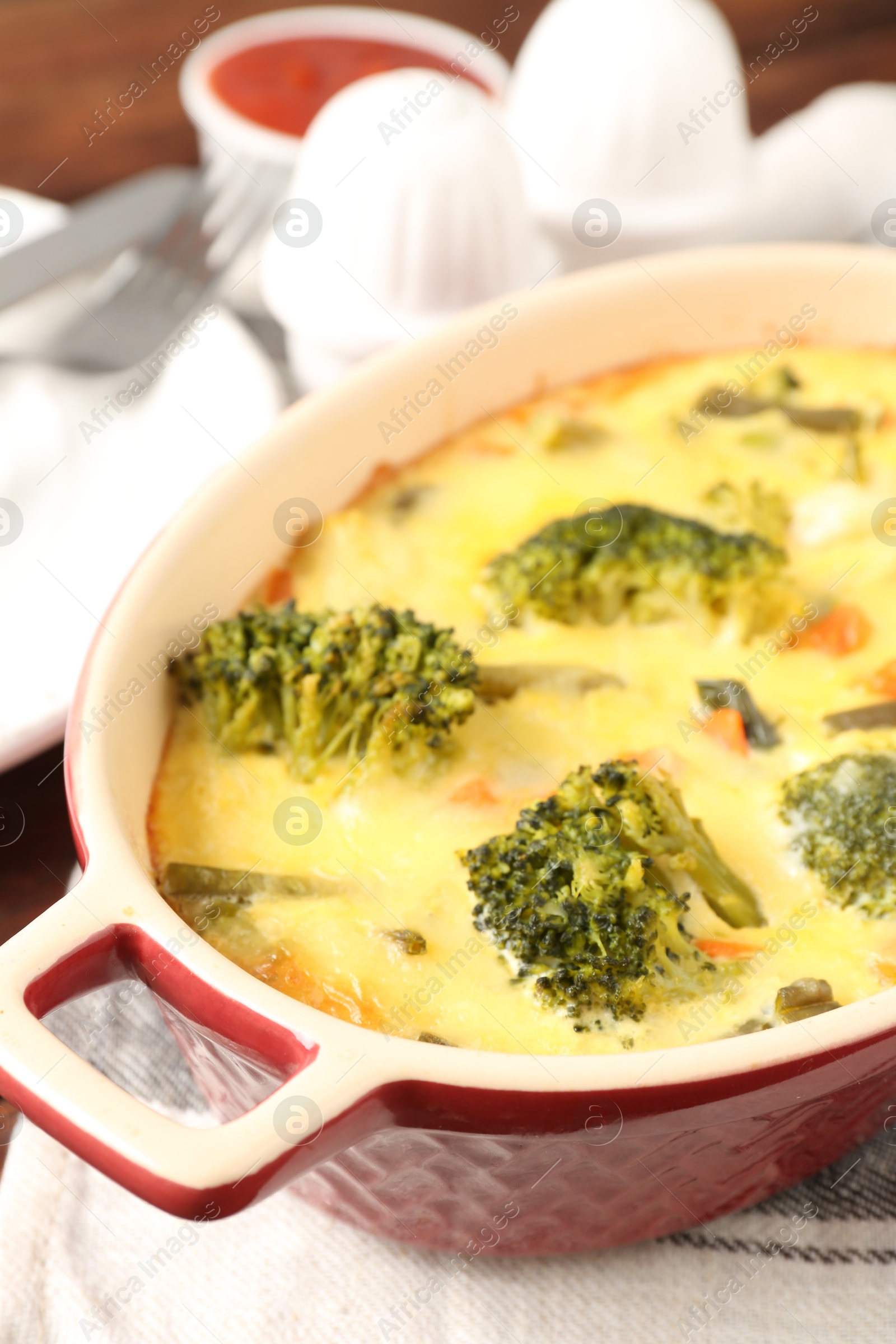 Photo of Delicious vegetable casserole on wooden table, closeup