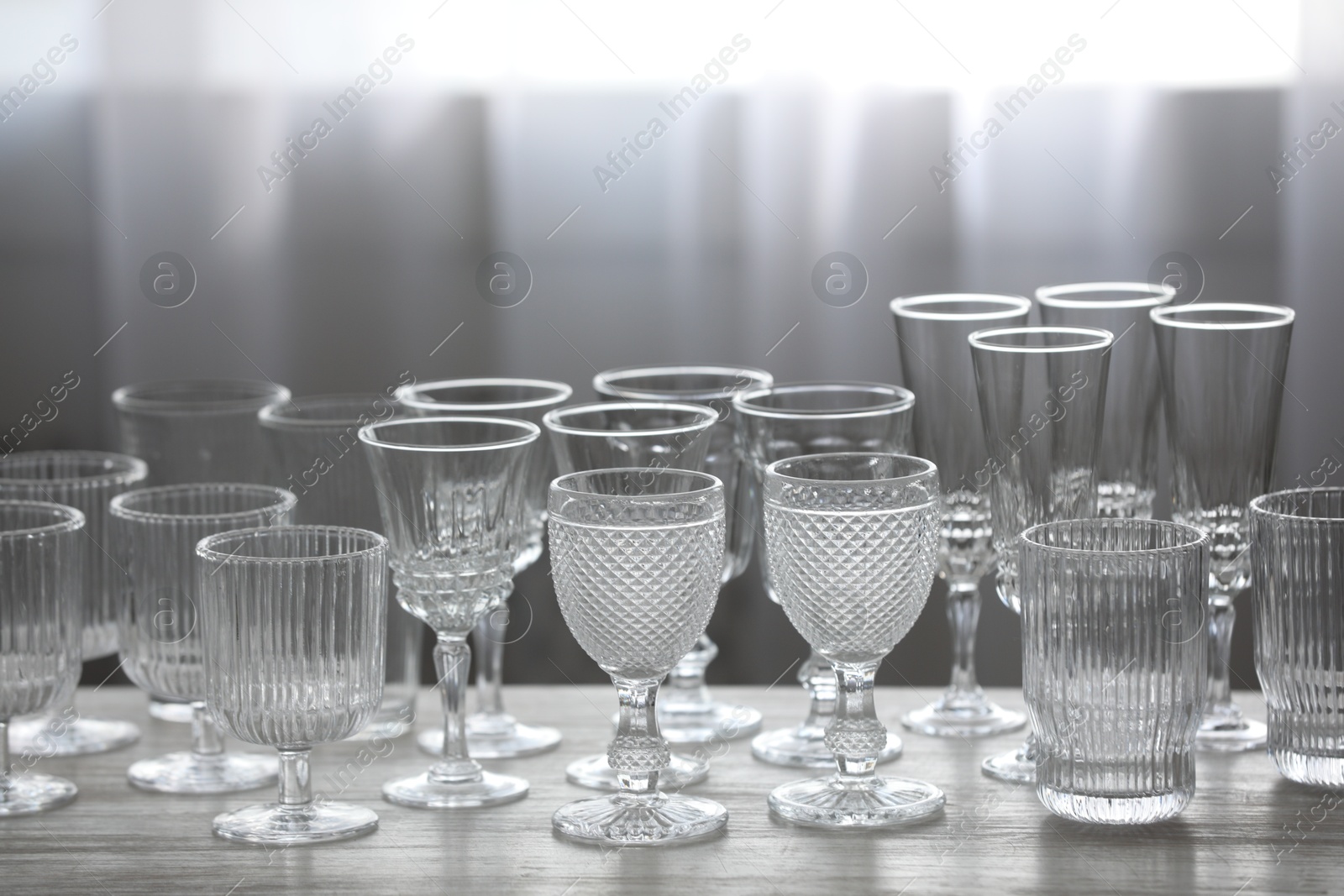 Photo of Empty clean glasses on wooden table indoors