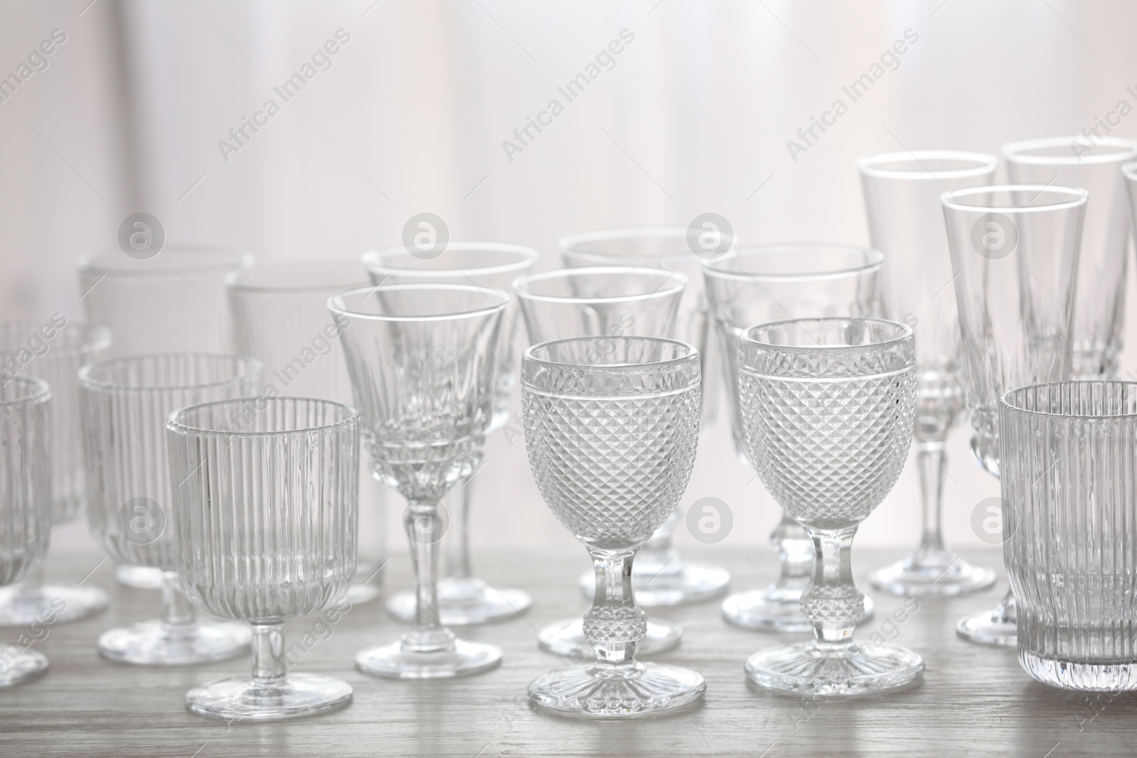 Photo of Empty clean glasses on wooden table indoors