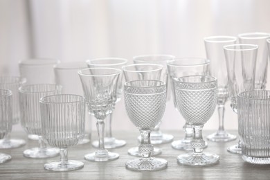 Photo of Empty clean glasses on wooden table indoors