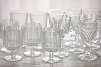 Photo of Empty clean glasses on wooden table indoors