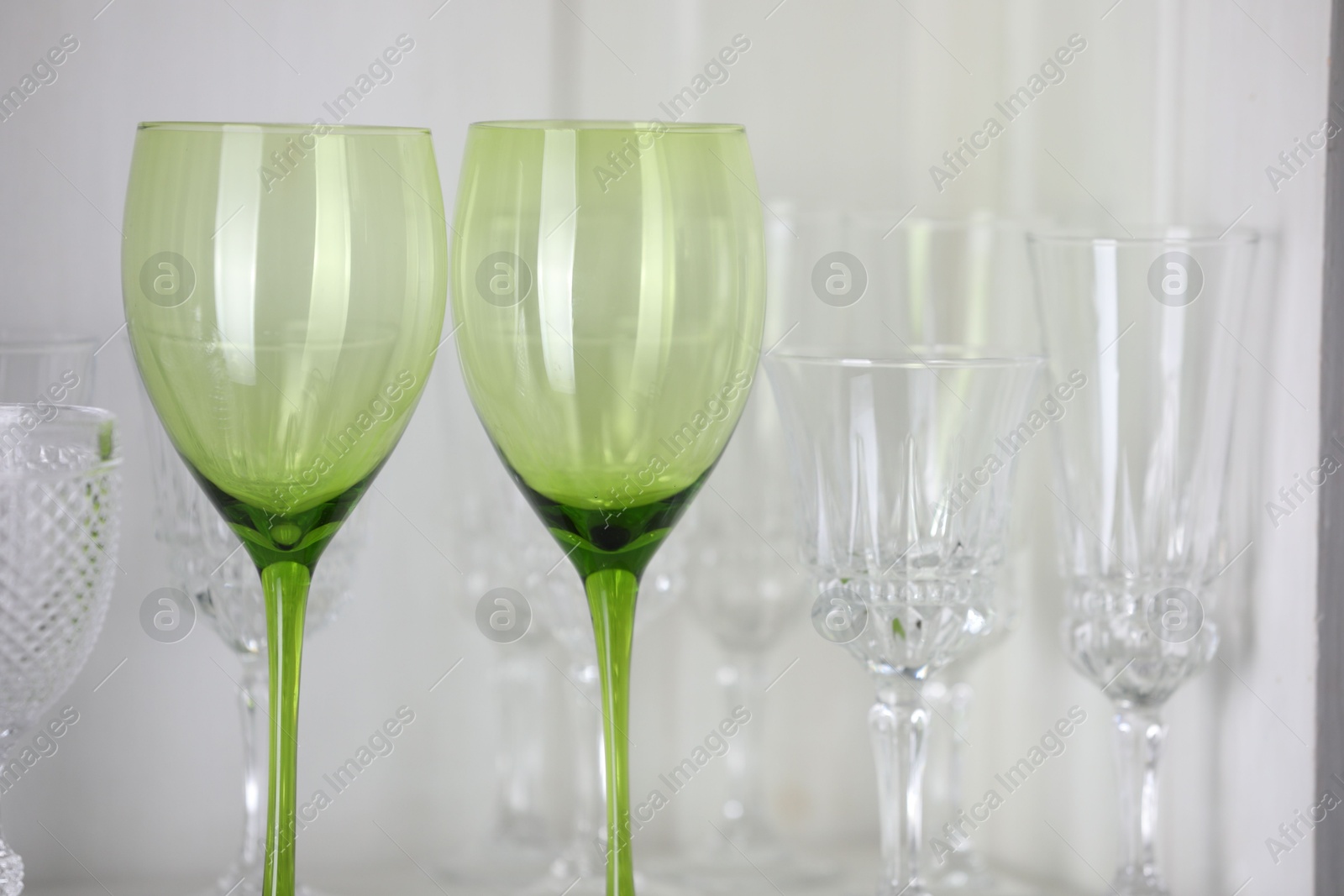 Photo of Different empty clean glasses on table, closeup