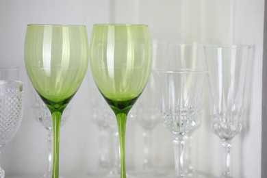 Photo of Different empty clean glasses on table, closeup