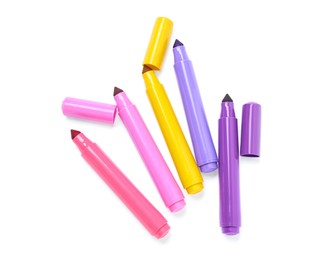 Photo of Many colorful markers and caps isolated on white, top view