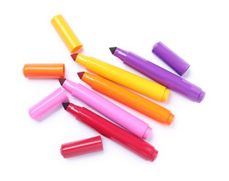 Photo of Many colorful markers and caps isolated on white, top view