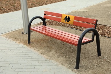 Image of Place where you can receive or give emotional support. Sign with human figures on bench outdoors