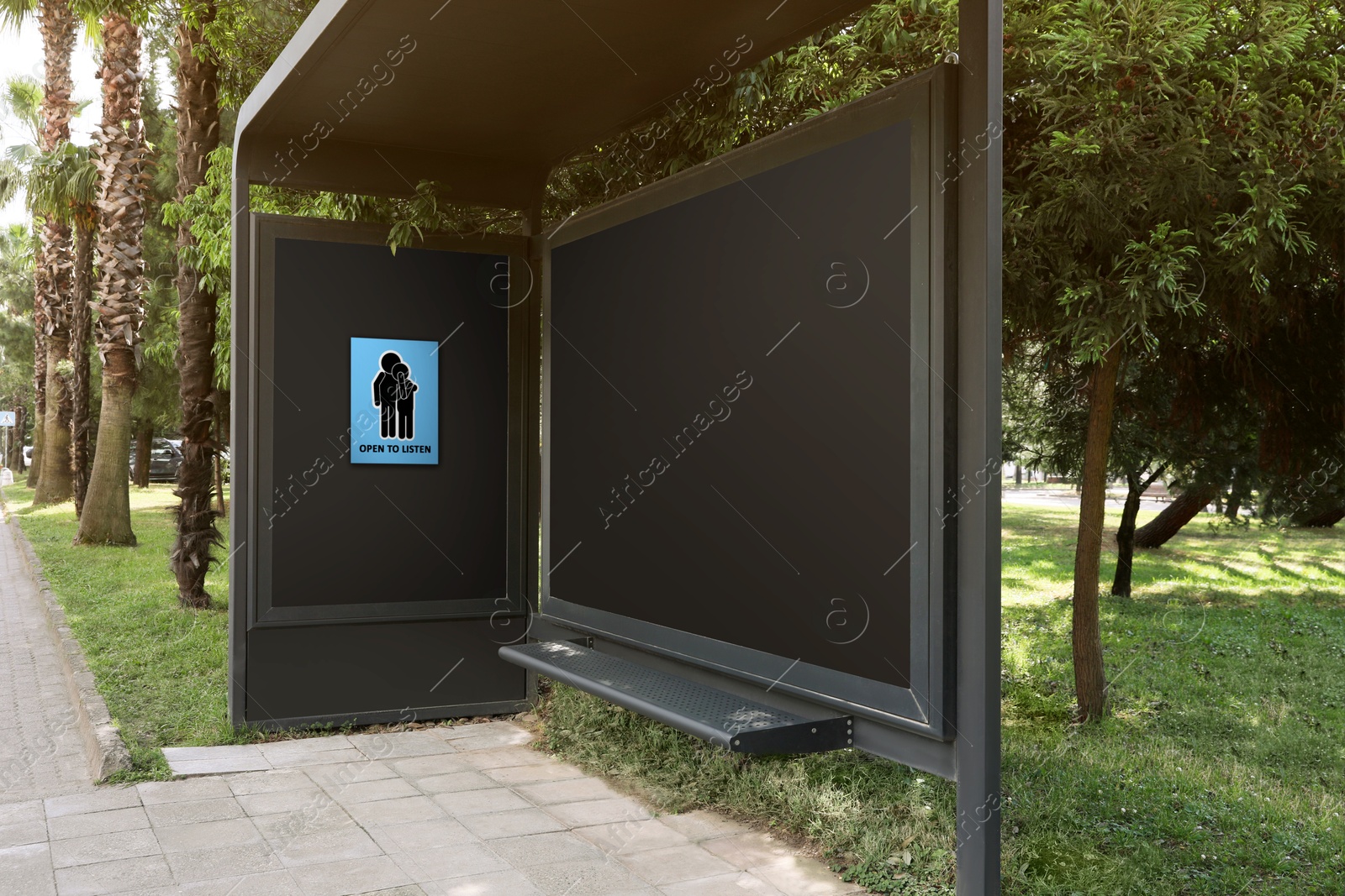 Image of Place where you can receive or give emotional support. Sign with human figures and text Open To Listen on advertising board at public transport stop outdoors